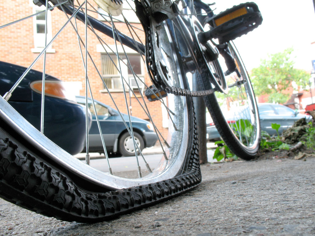 a bike with a flat tire Closeup of rear flat tire on a bicycle
